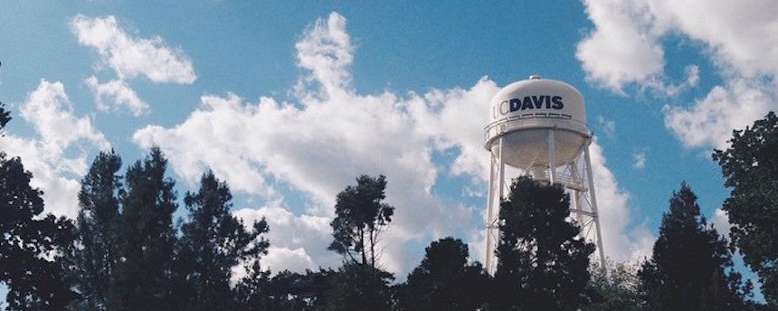 UC Davis water tower emerging behind trees