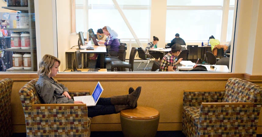 Student with laptop reclining on couch