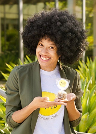 A woman shows off her snack product