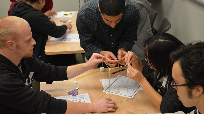 Students work with spaghetti and marshmallows for a team-building exercise