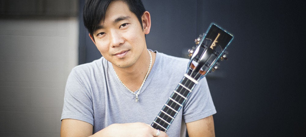 Jake Shimabukuro holding a ukelele.