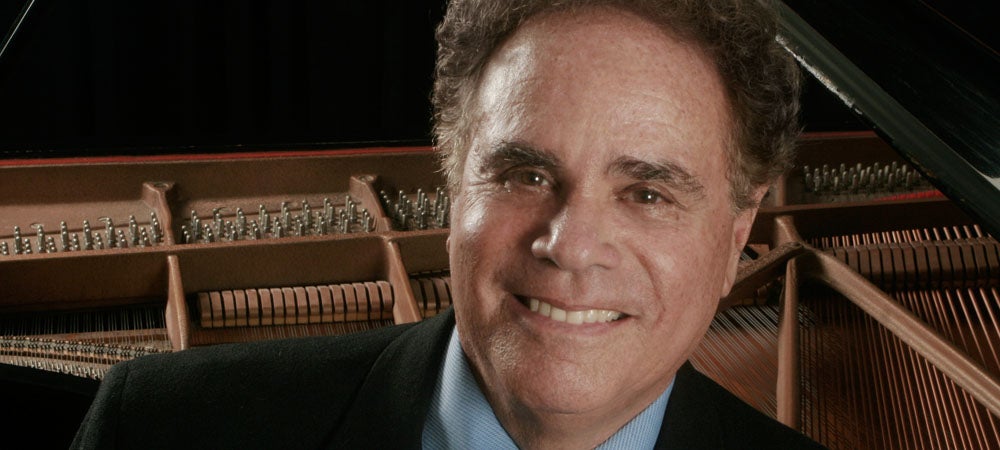 Pianist Jeffrey Siegel sitting at the piano.