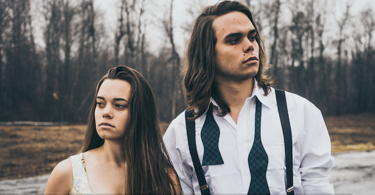 Jocelyn and Chris Arndt standing in front of trees.