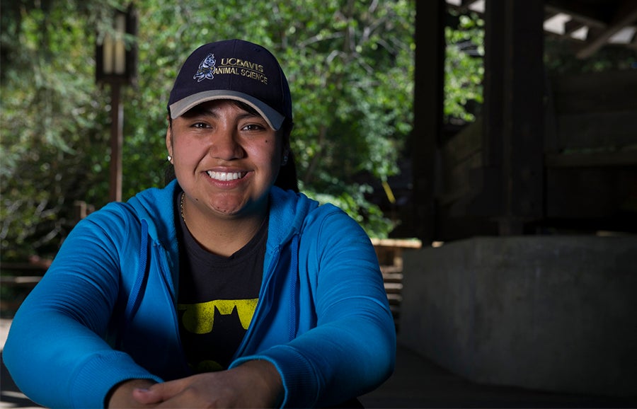 A woman sits outdoors