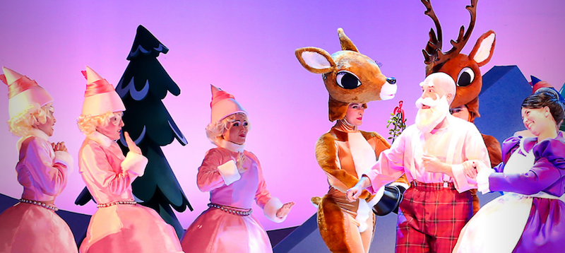 A scene with Rudolph, Santa Claus, Mrs. Clause and three of Santa's elves.