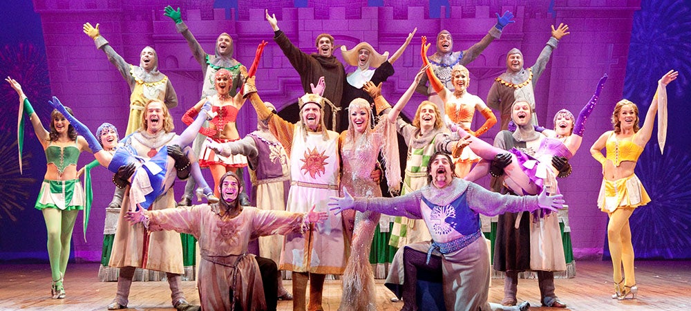 The cast of Spamalot on stage.