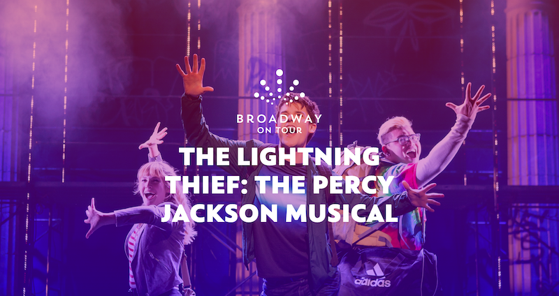 Members of the cast singing and dancing on stage.